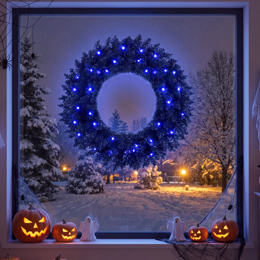 24-inch pre-lit Halloween wreath featuring 35 purple LED lights, perfect for festive indoor decoration and creating a spooky atmosphere.