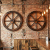 Set of 2 decorative wooden wagon wheels, 24-inch diameter, carbonized fir wood, ideal for rustic wall decor.
