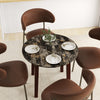 Round dining table with brown marble-textured veneer and rubber wood legs, perfect for dining and working.