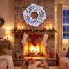 24-inch pre-lit Christmas wreath with frosted branch tips and multicolored LED lights above a festive fireplace.