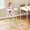Pink Easy Clean Compact Highchair with a child seated, featuring an adjustable tray and safety harness for secure.