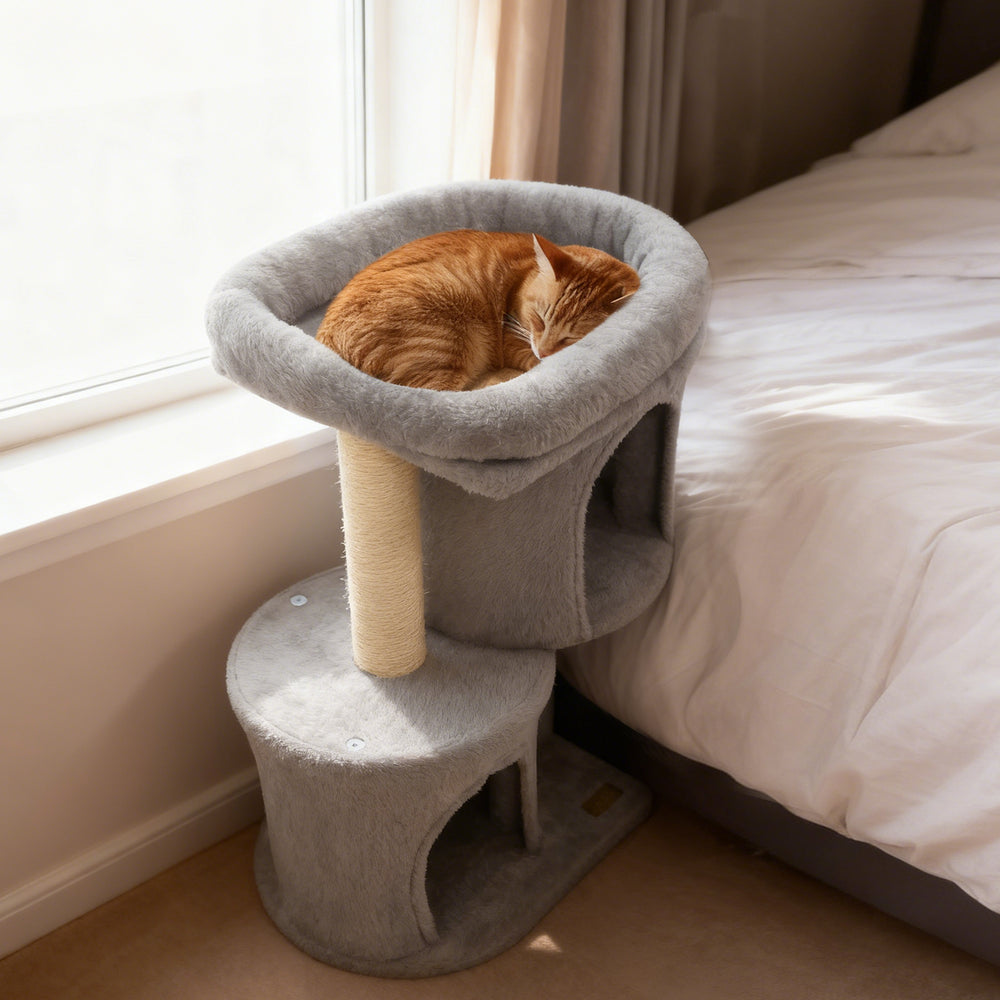 Cozy light gray cat tower with large padded perch and dual condos, perfect for napping and hiding.