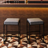 Stylish gray bar stool with a 4" thick faux leather seat and sturdy metal frame, ideal for home bars and dining areas.