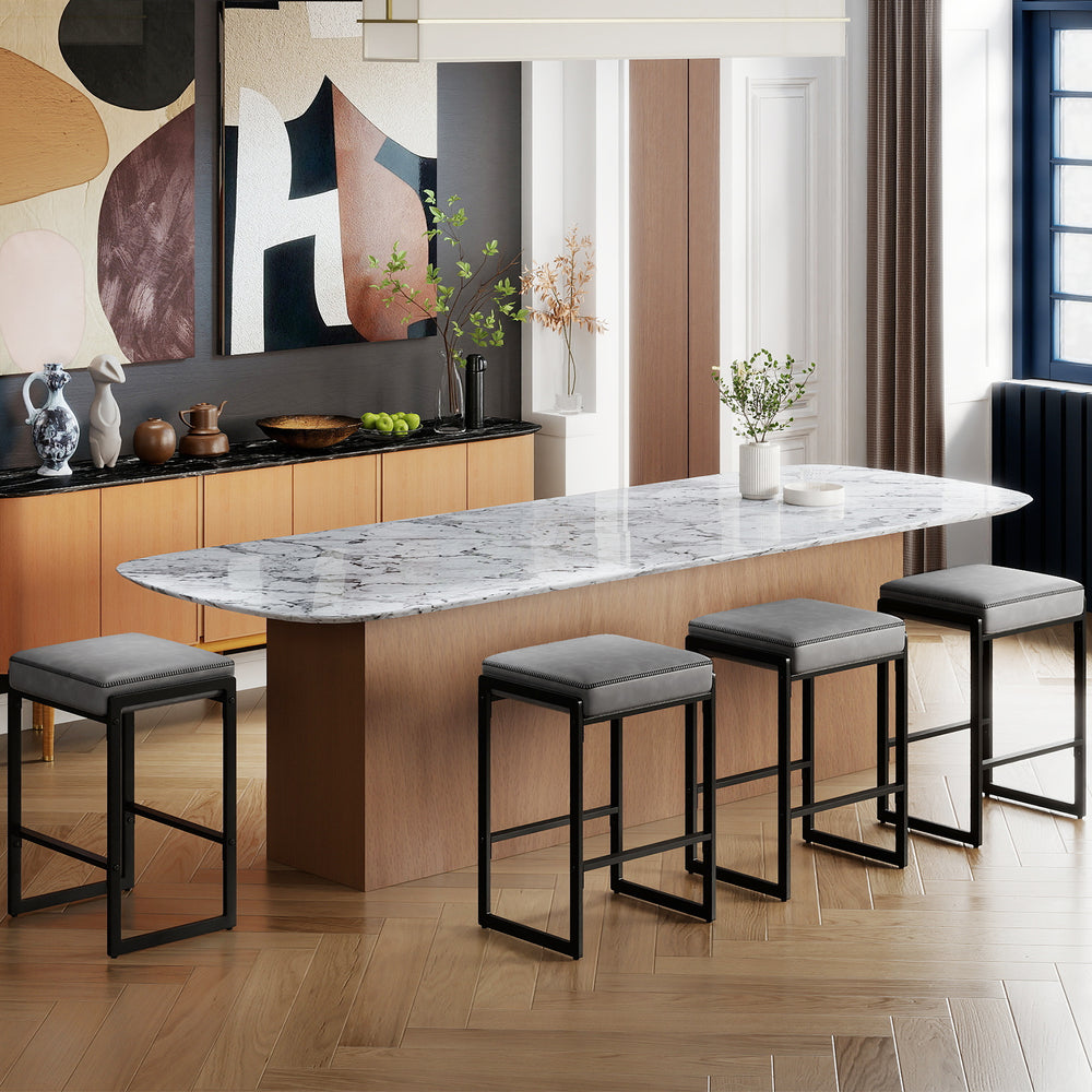 Gray bar stools with faux leather seats and metal frames, perfect for kitchen islands or home bars, shown in a modern.