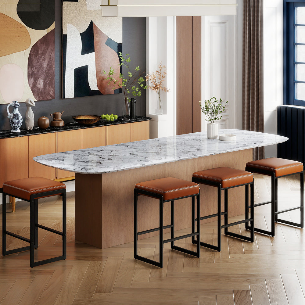 Set of four 26-inch bar stools with brown faux leather seats and sturdy metal frames, perfect for kitchen islands.