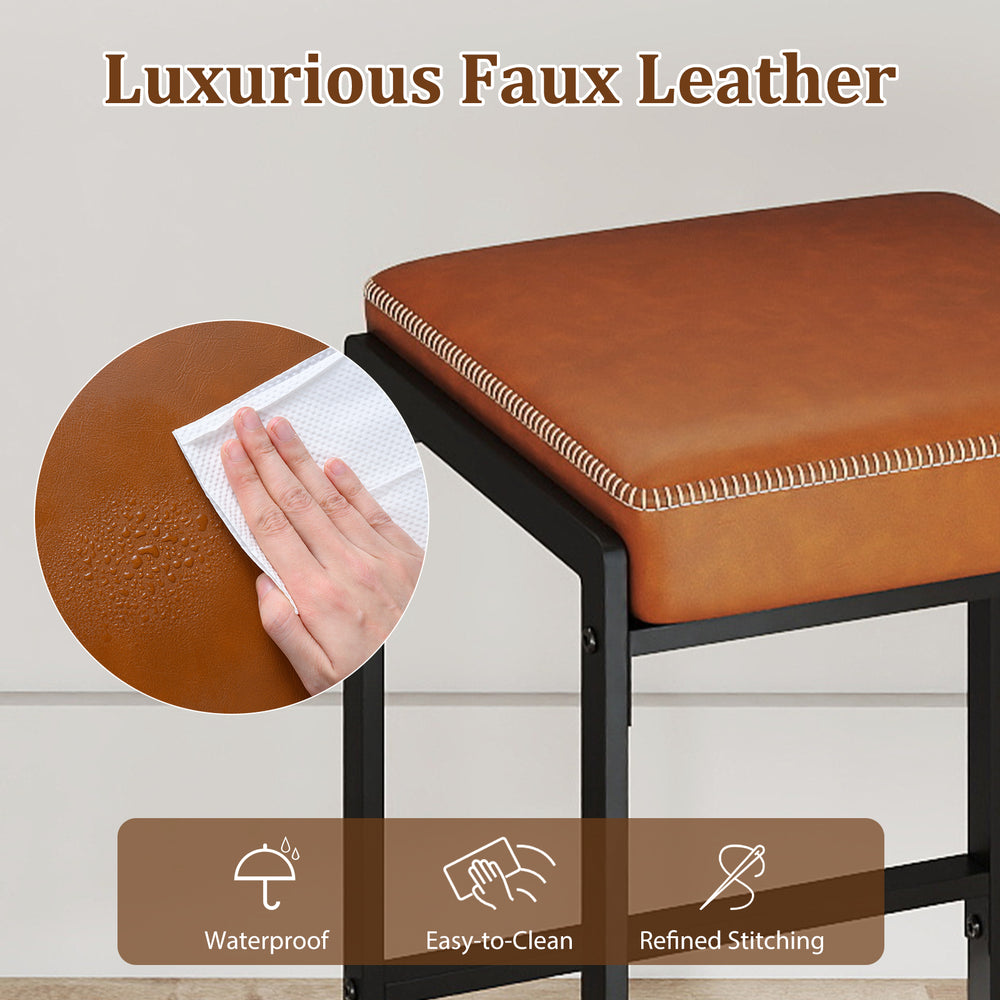 Close-up of the brown faux leather seat of a 26-inch bar stool, featuring waterproof material and refined stitching.