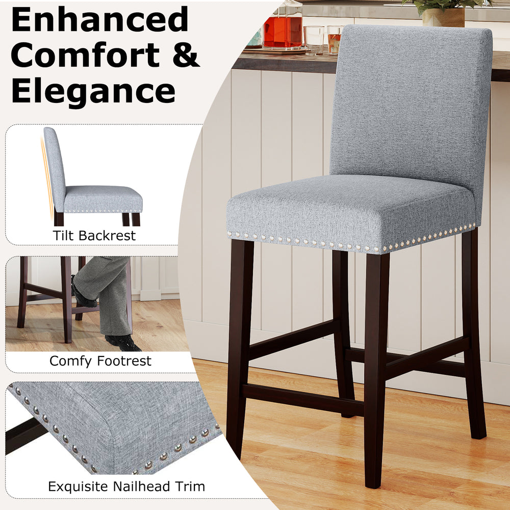Gray padded counter height chair with tilt backrest and nailhead trim, ideal for kitchen islands or cafes.