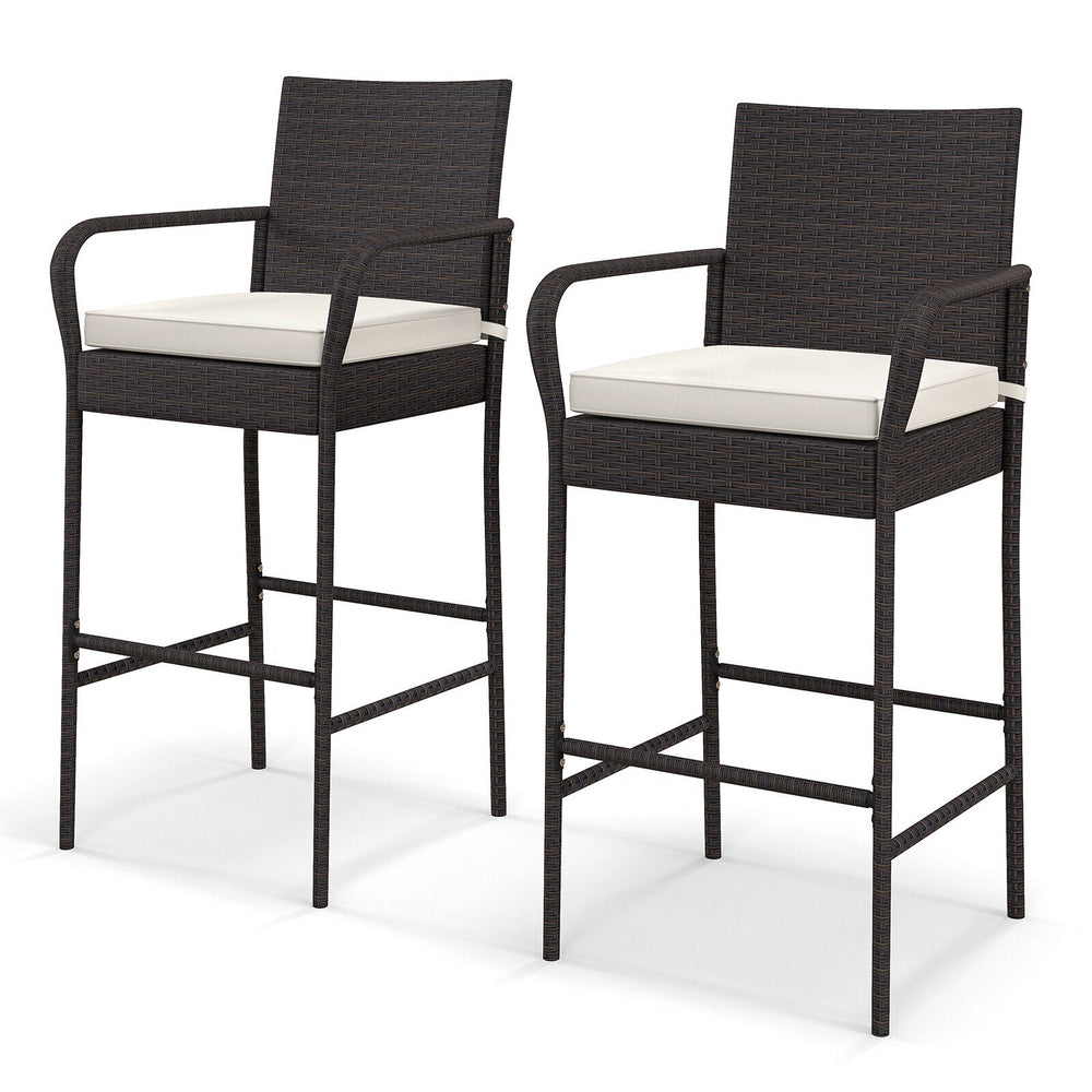 Set of 2 outdoor PE rattan barstools with armrests and cushions, ideal for patio, balcony, or poolside use.