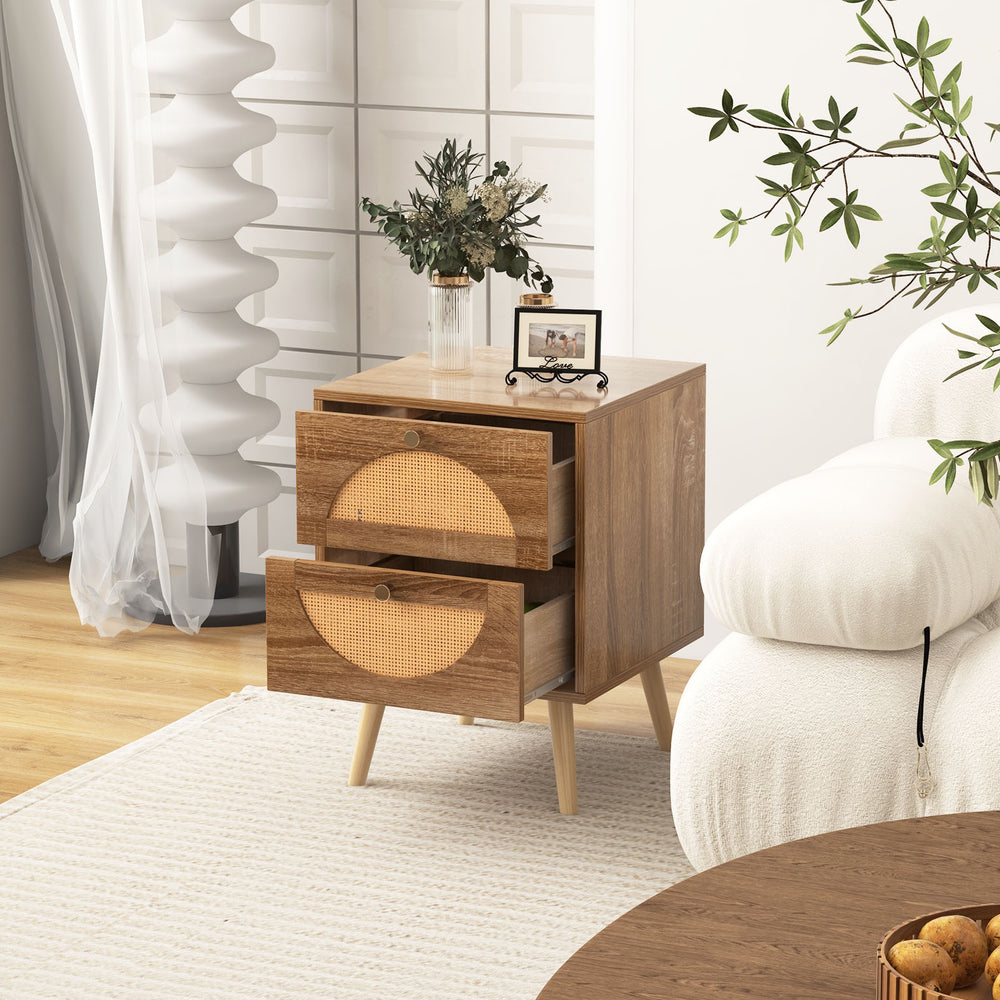 Rattan nightstand with two drawers and solid wood legs, featuring a charming bohemian style for bedroom or living room.