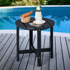 Round black weather-resistant Adirondack side table with slatted top, perfect for outdoor use by the pool.
