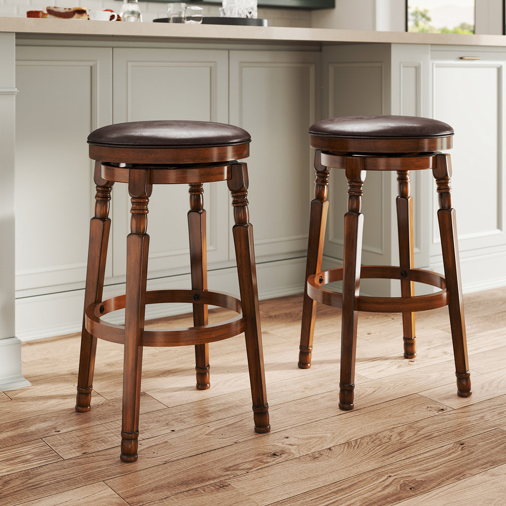 Set of 2 29-inch swivel bar stools with leather padding and walnut finish, perfect for kitchen or pub use.