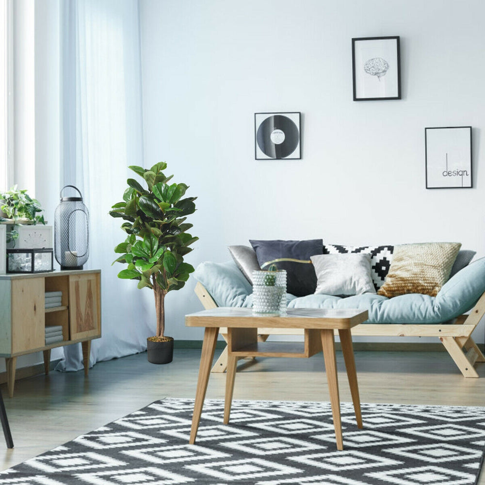 4 feet artificial fiddle leaf fig tree in decorative planter, perfect for indoor decor with natural-looking leaves.