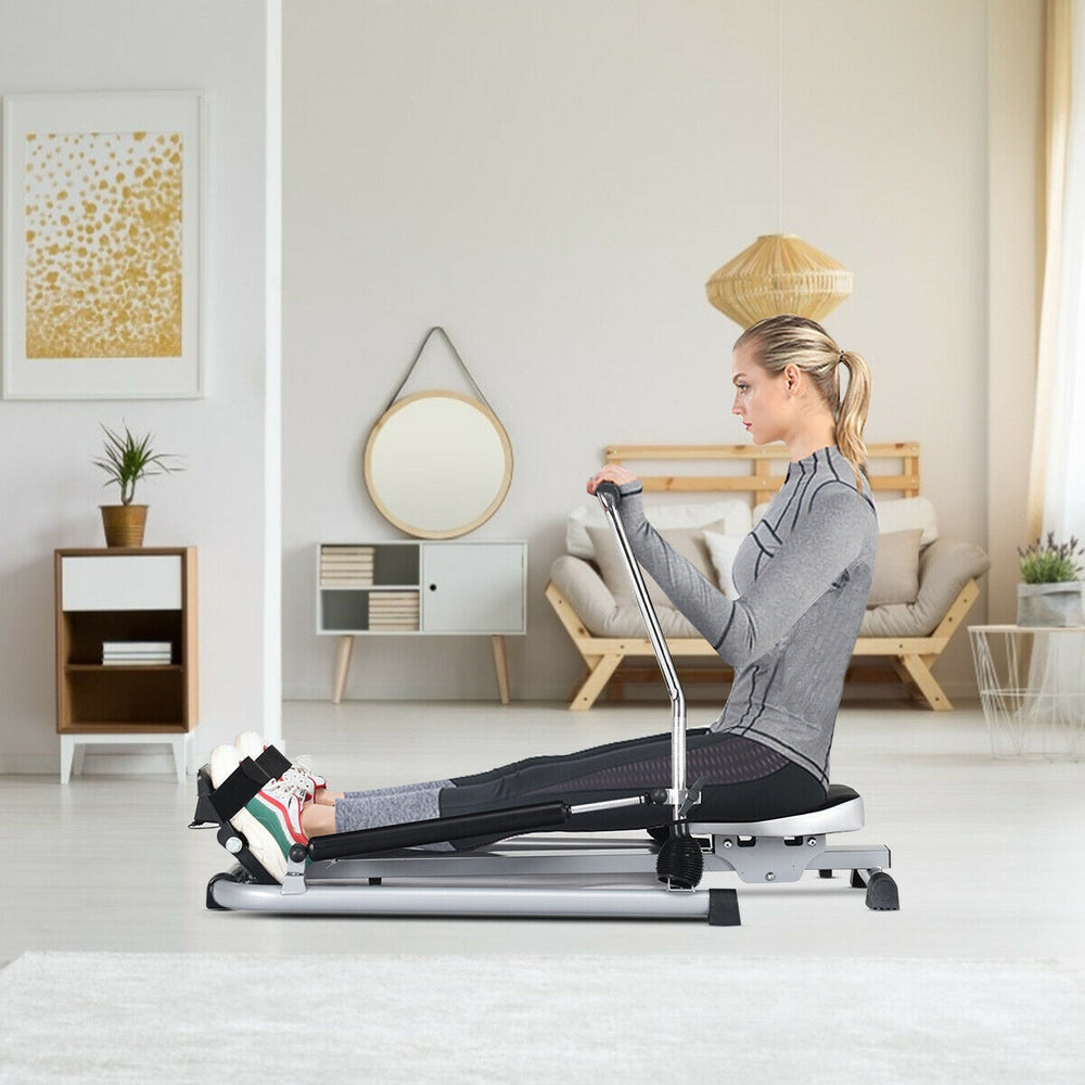 Adjustable double hydraulic resistance rowing machine with a user demonstrating a full-body workout in a modern home.