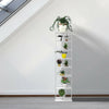 7-tier white wooden shoe rack organizer with plants, perfect for keeping shoes tidy in hallways or rooms.