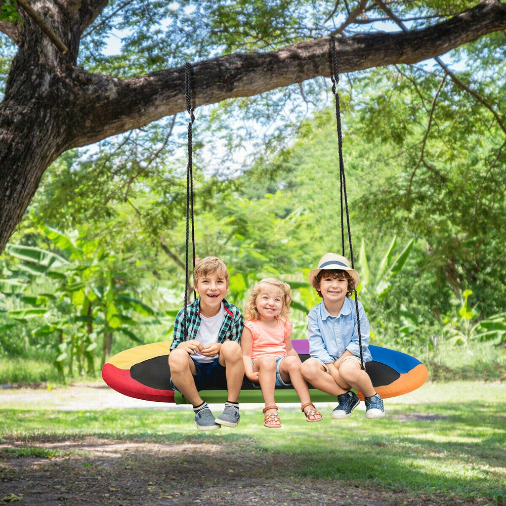Colorful 60-inch saucer swing with three children enjoying outdoor play, adjustable height for versatile use.