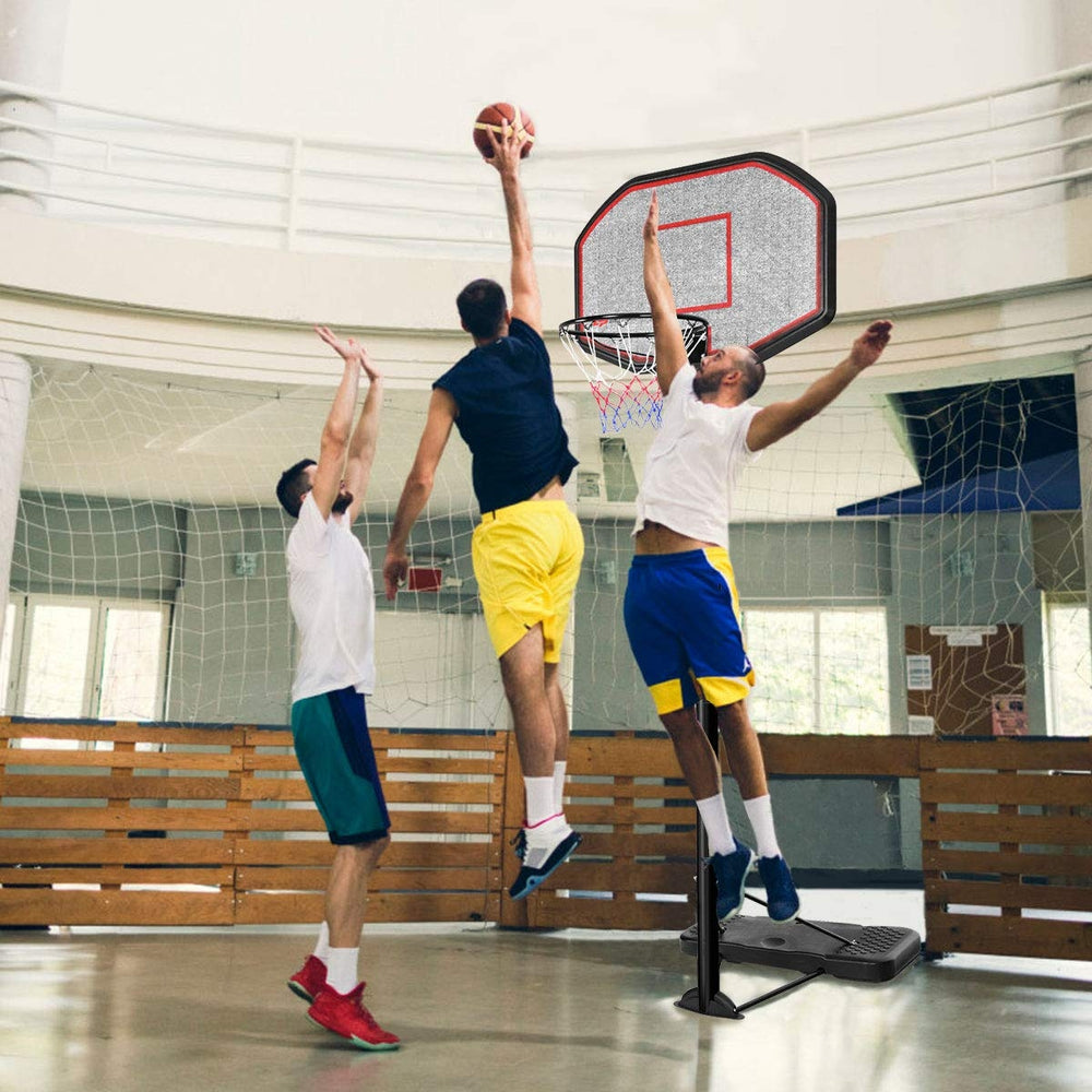 Height adjustable 43-inch basketball hoop with durable steel frame, shown in use during a game indoors.