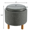 Round gray fabric storage ottoman with removable lid and wooden tray, featuring non-slip pads for stability and comfort.