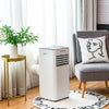 Portable air conditioner in white with remote control, 10000 BTU cooling, placed beside a chair for versatile home use.