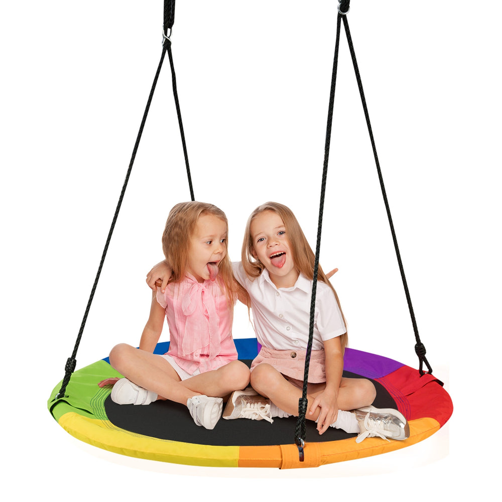 Two children sitting on a 40-inch rainbow flying saucer tree swing, designed for outdoor play and easy installation.