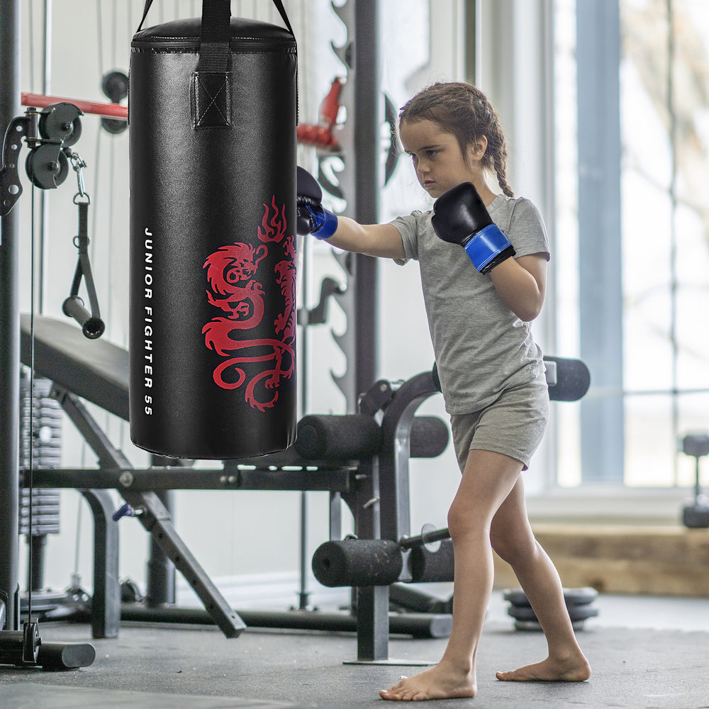 Child practicing boxing with a punch bag, wearing gloves from the 2 Feet Kids Gloves Skipping Rope Boxing Set.