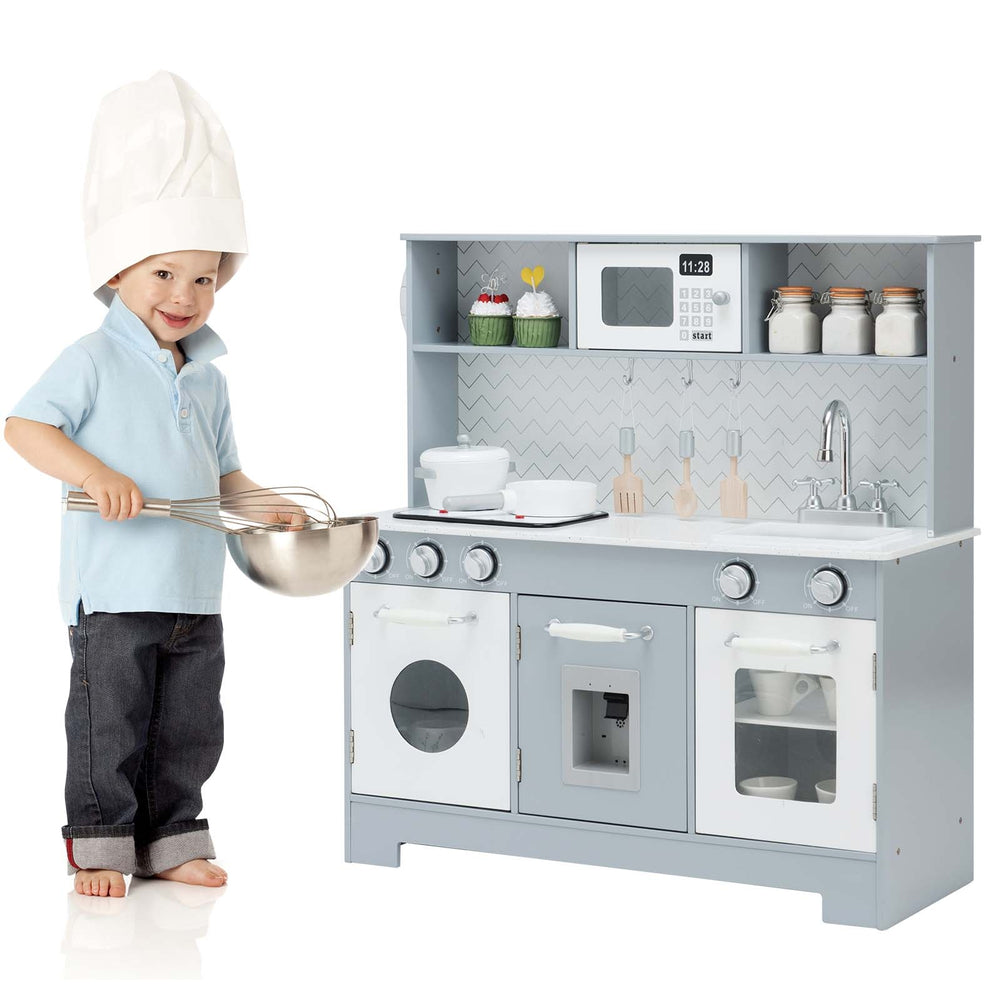 Child playing with a pretend play kitchen wooden toy set featuring realistic light and sound, perfect for imaginative.