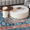 Round coffee table with a marble top and a vintage area rug, perfect for living room or bedroom decor.