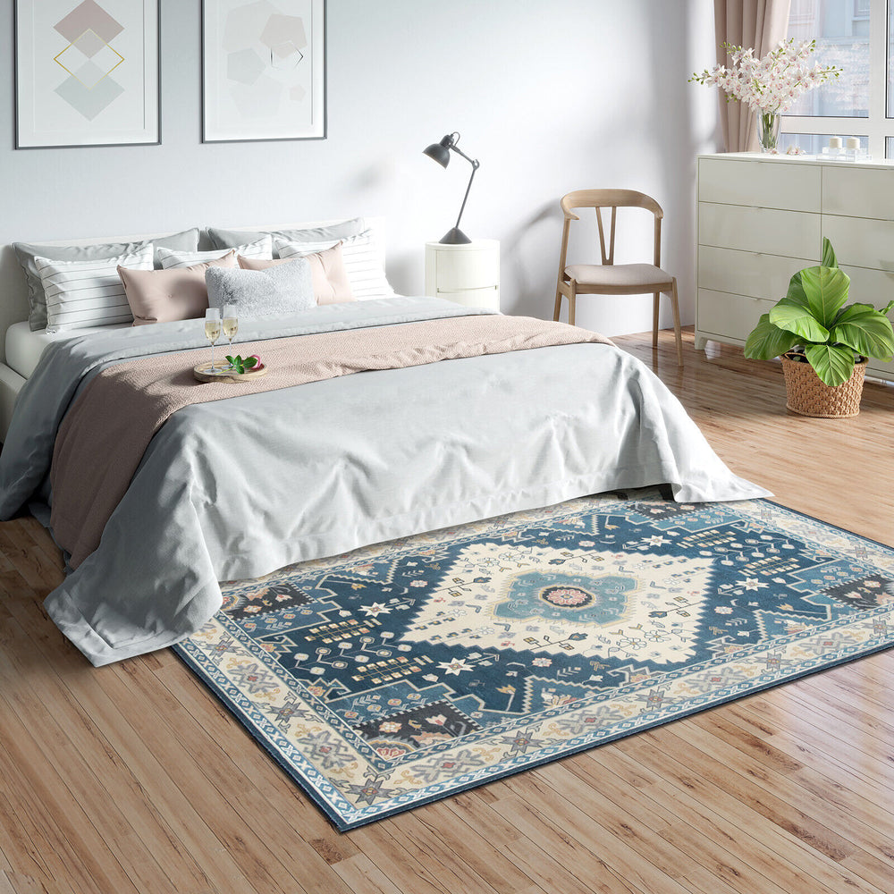 Faux wool area rug in blue with intricate pattern, ideal for living room or bedroom, offering comfort and easy.