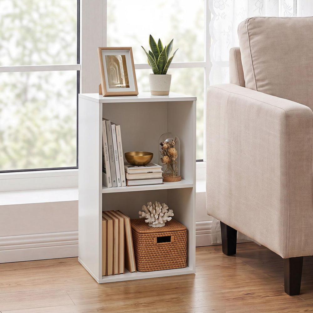 Freestanding white bookshelf with two open cubes, ideal for storage in living rooms or home offices.