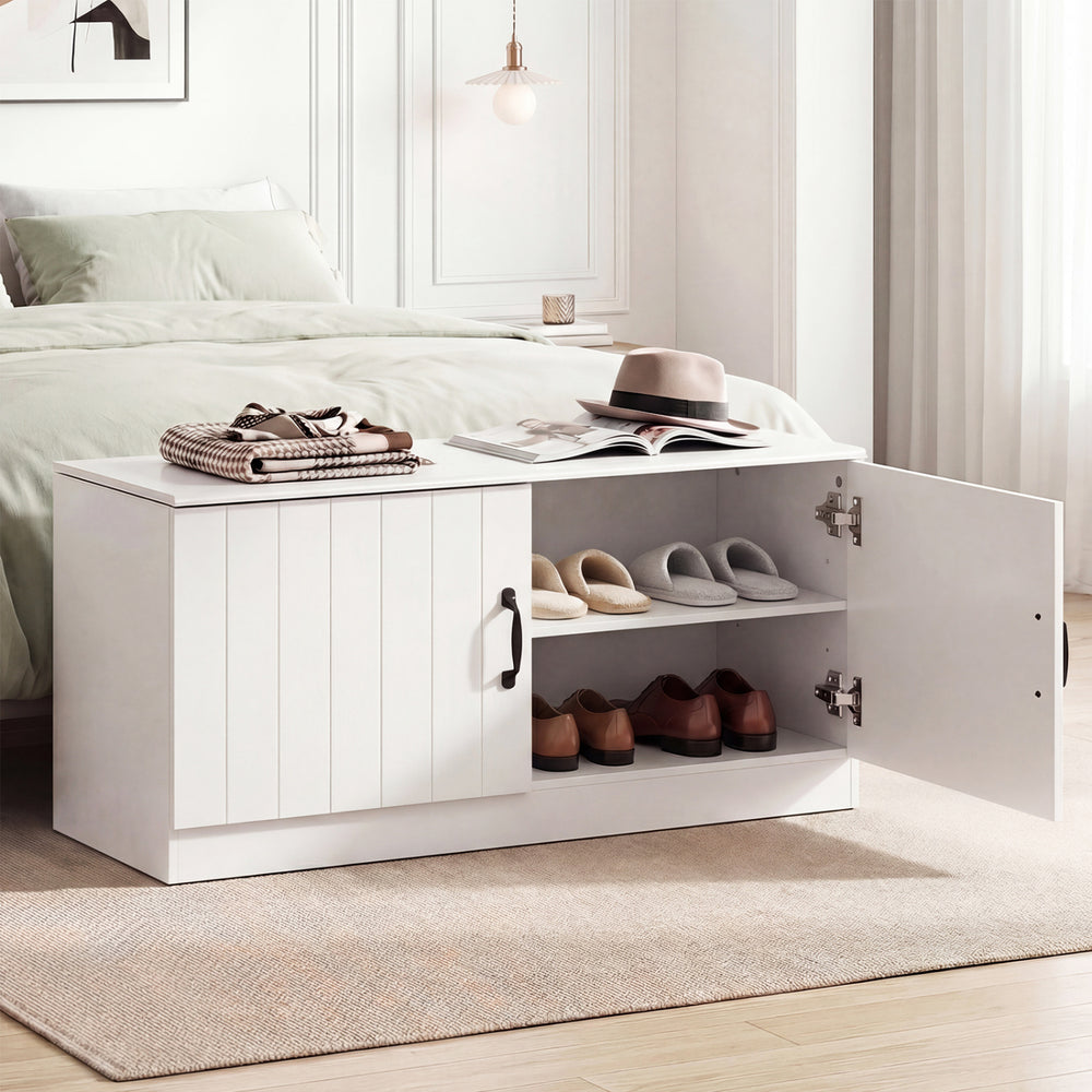 White 2-door shoe storage cabinet with adjustable shelves, offering seating and shoe organization for entryways or.