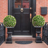 Two 17.5-inch artificial topiary balls with pink flowers in decorative planters, ideal for front porch or garden decor.