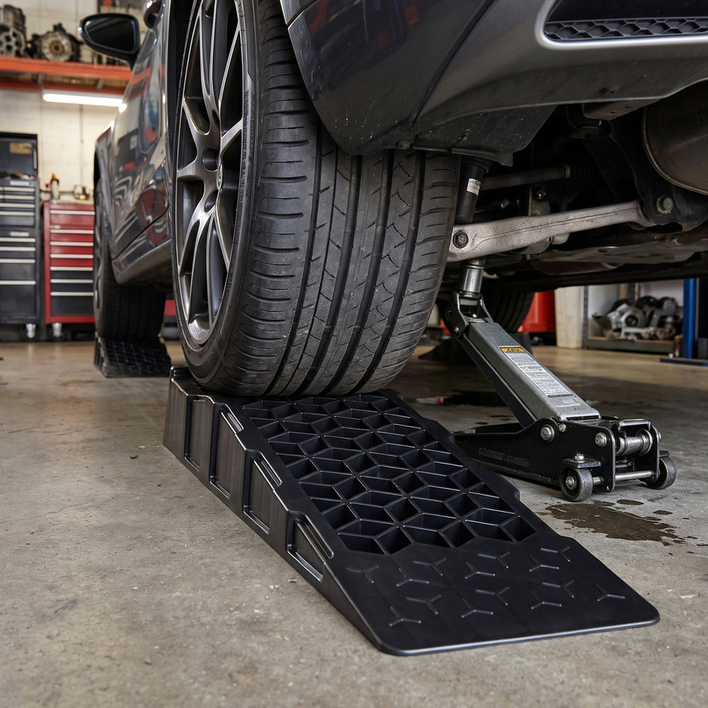 Low-profile car ramp set lifts vehicles 2.5"/6.5 cm for maintenance, featuring anti-slip texture and 22,000 lbs capacity.