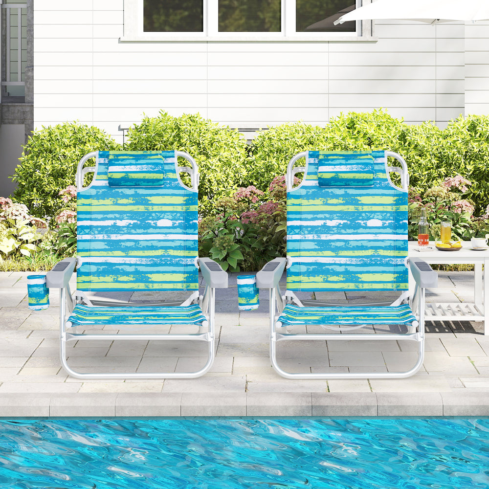 Two folding beach chairs with adjustable positions in blue and green, perfect for outdoor relaxation by the pool.