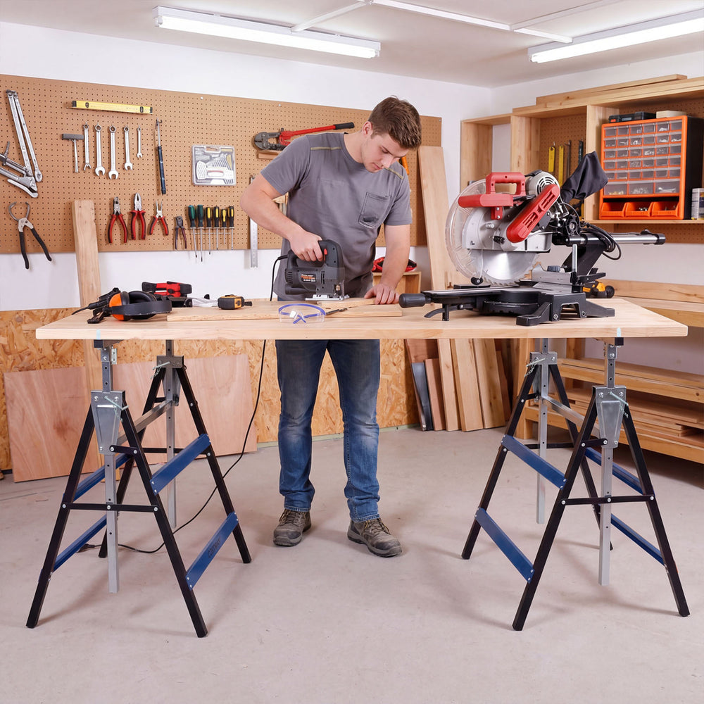 Heavy-duty metal folding saw horses in blue with adjustable height, ideal for contractors and DIY projects in workshops.