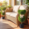 Two bear-shaped topiary trees with golden bows in cement-filled pots, perfect for playful outdoor decoration.