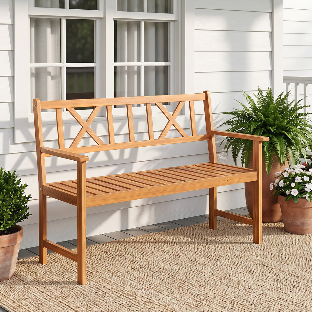 Acacia wood 2-person garden chair features an X-shaped backrest and armrests, ideal for patios and gardens.
