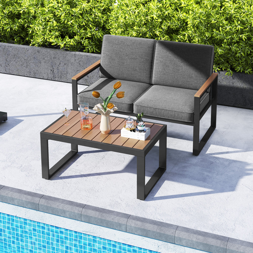 Gray 2-piece patio furniture set featuring a loveseat and coffee table with wood-plastic armrests, ideal for poolside.