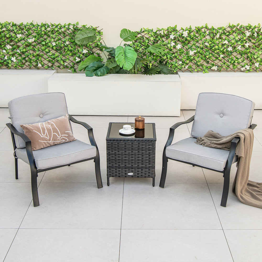 Two ergonomic patio metal chairs with soft cushions and a small table, perfect for backyard or poolside relaxation.