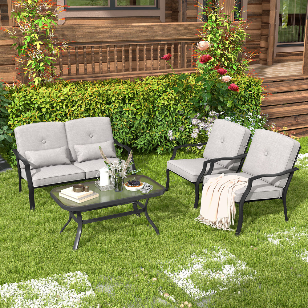 Two ergonomic patio metal chairs with soft cushions and a coffee table, perfect for backyard relaxation.
