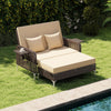 Brown rattan loveseat and ottoman with adjustable backrest, soft cushions, perfect for poolside relaxation.