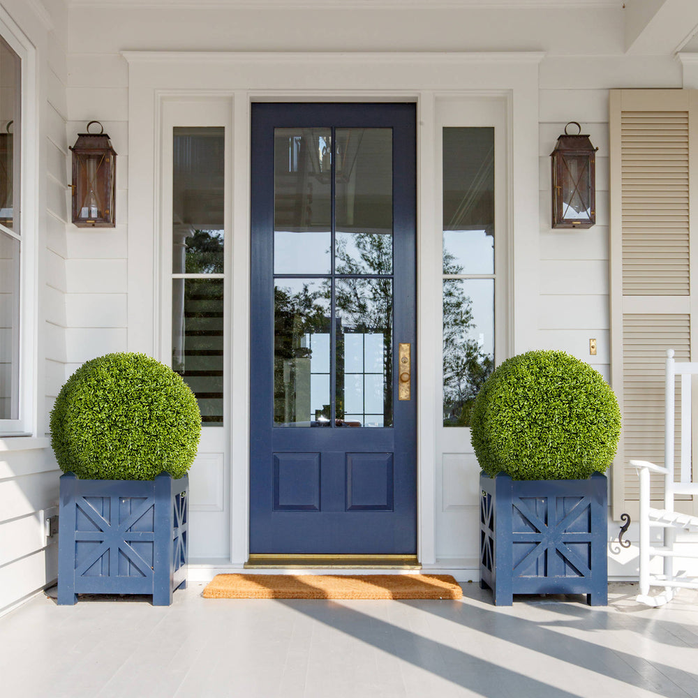 Two 20-inch artificial topiary spheres in blue planters, perfect for front door or patio decoration.