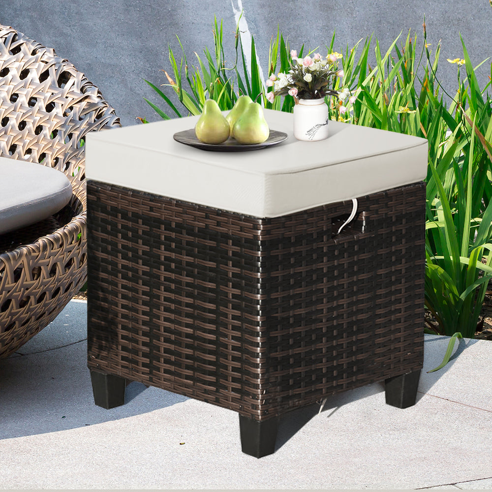 Rattan ottoman with removable beige cushion, sturdy steel frame, ideal for outdoor seating or as a coffee table.