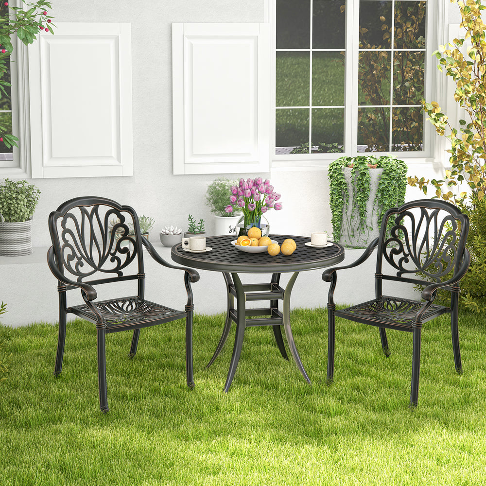 Patio dining set featuring two bronze cast aluminum chairs with armrests, perfect for outdoor garden relaxation.