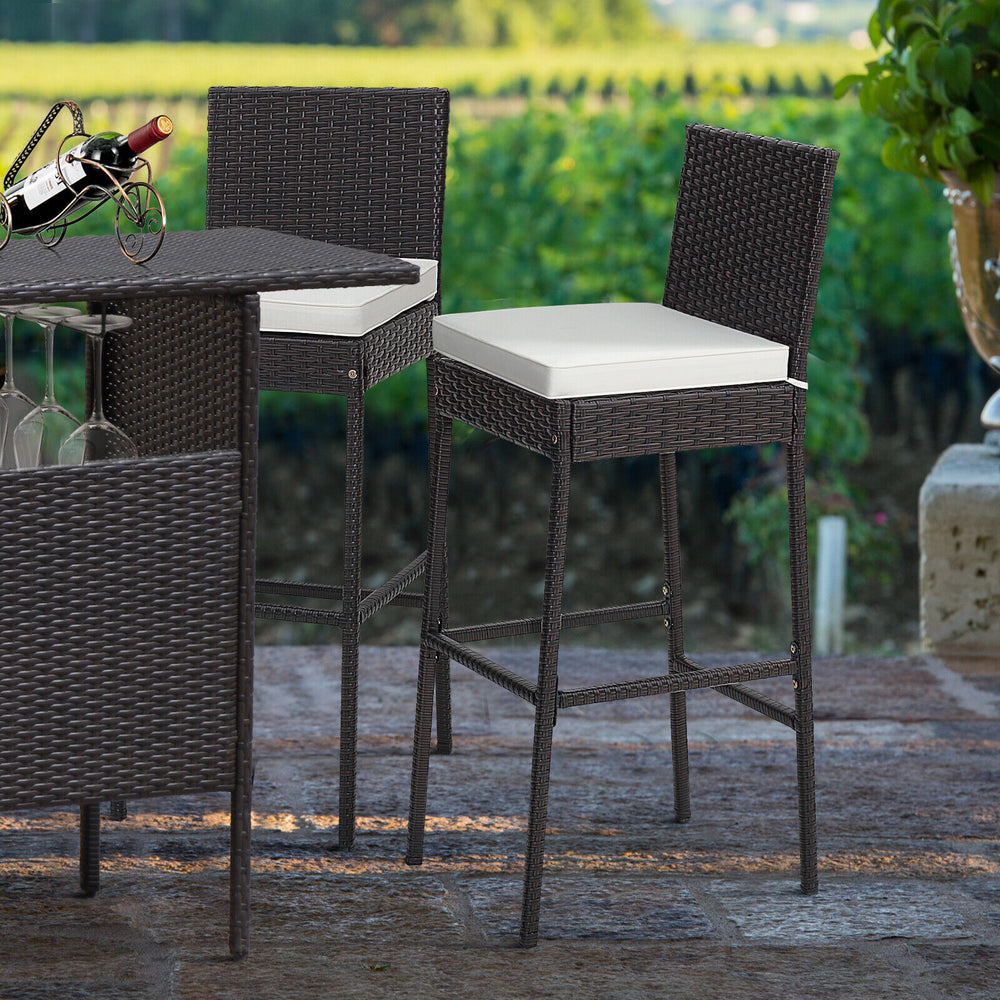 Two cushioned wicker barstools with a cozy footrest, featuring hand-woven PE rattan, ideal for outdoor patio use.