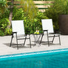 Two white patio folding chairs with armrests by the pool, featuring a sturdy metal frame and portable design for.