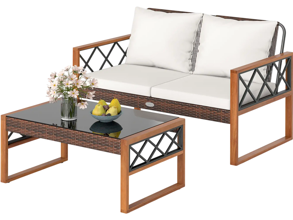 Two-piece patio furniture set featuring a white cushioned loveseat and glass-top coffee table for outdoor relaxation.