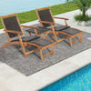 Two folding lounge chairs with acacia wood frames and PE wicker, perfect for relaxing by the poolside.