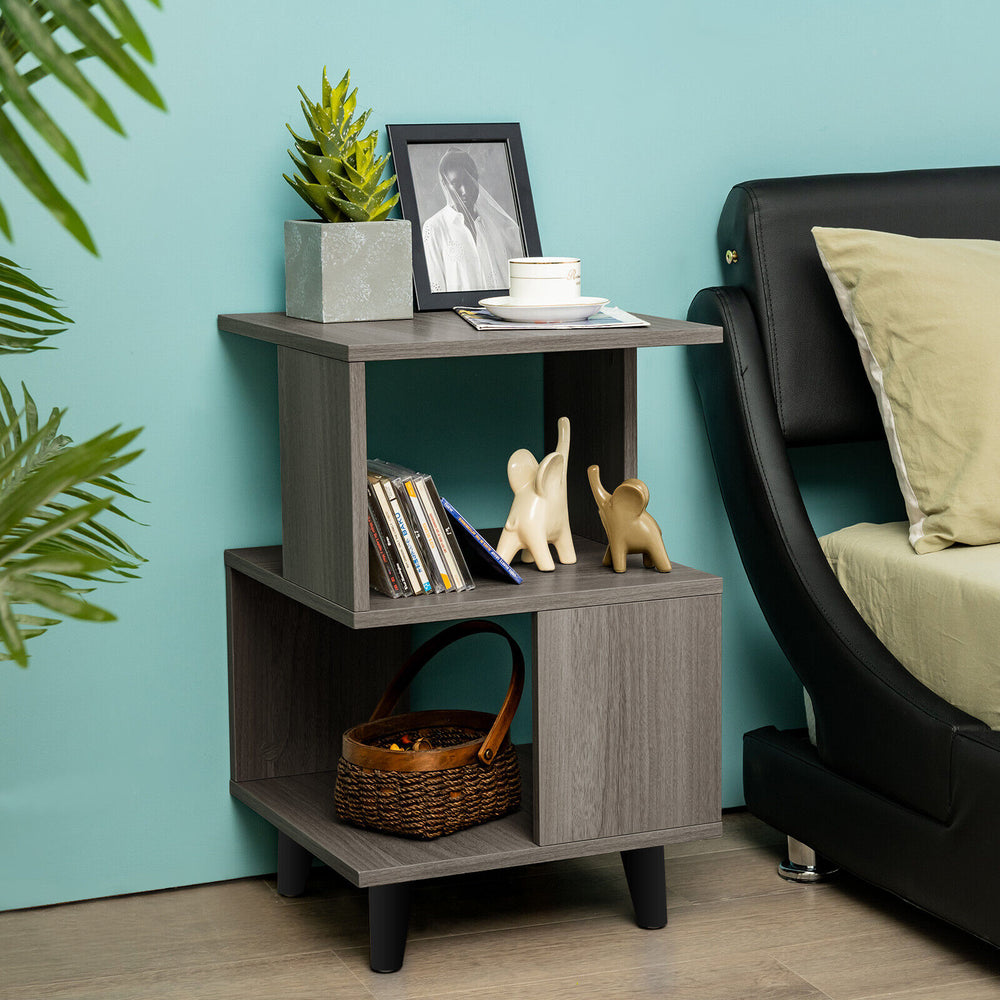 Modern wooden nightstand with asymmetrical design, featuring storage space and stable legs, perfect for small living.