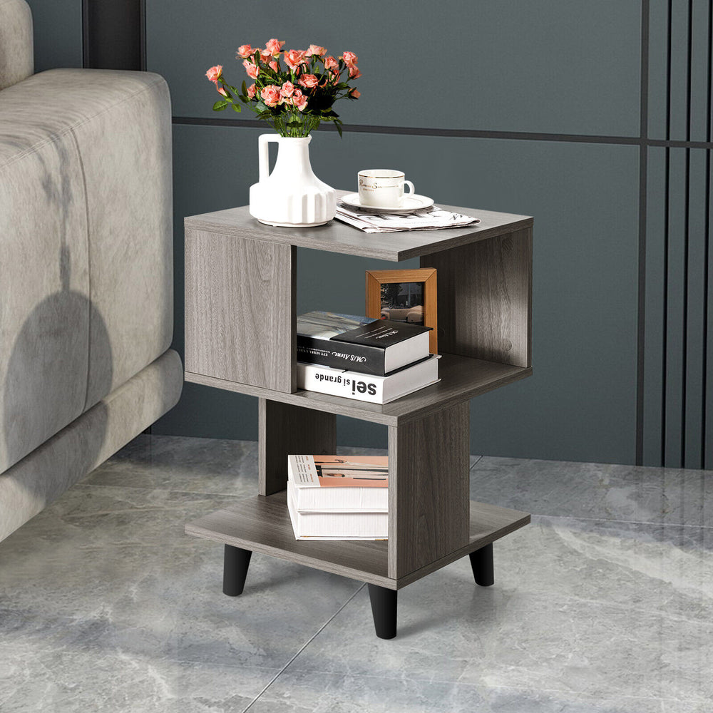 Modern wooden nightstand with asymmetrical design, featuring storage space and sturdy legs, ideal for small living.