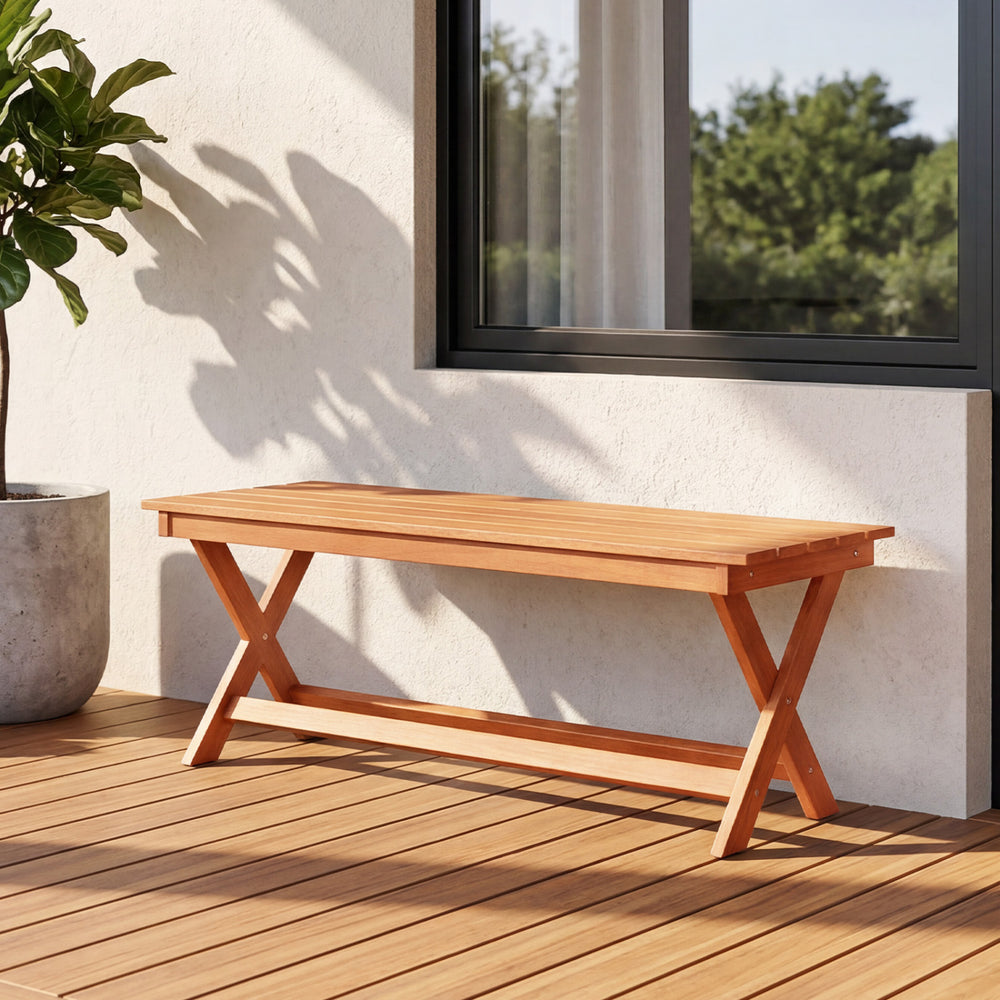 2-seat wooden garden patio bench with X-shaped legs, placed on a deck, perfect for outdoor relaxation.