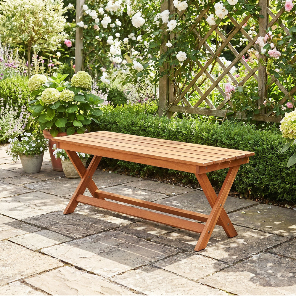 2-seat wooden garden patio bench with X-shaped legs, placed in a lush garden setting for outdoor relaxation.